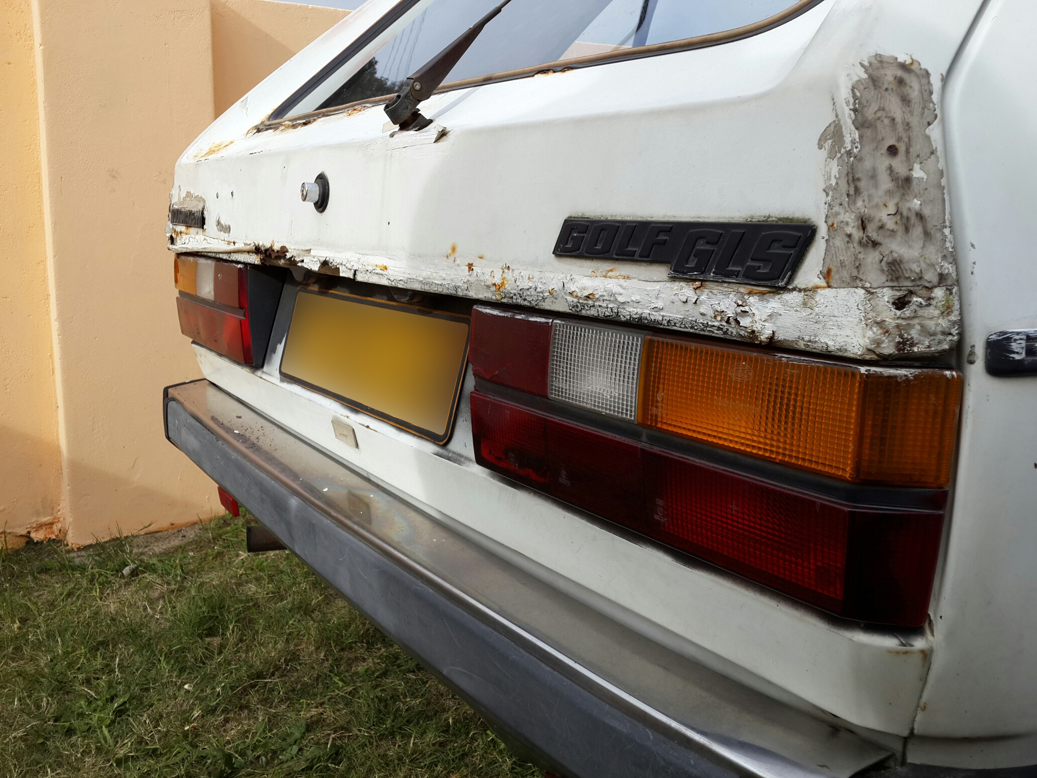 The larger, flared, bumpers. Some nice patch work done, with what appears to be some kind of silicone, tape and house paint